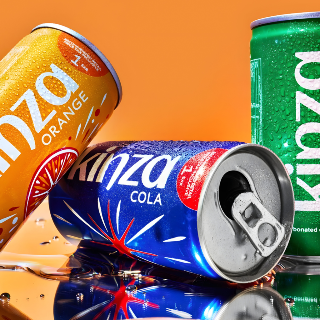 Open Kinza Cola can lying between Orange and green cans on an orange background